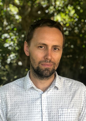 Man facing camera in patterned shirt